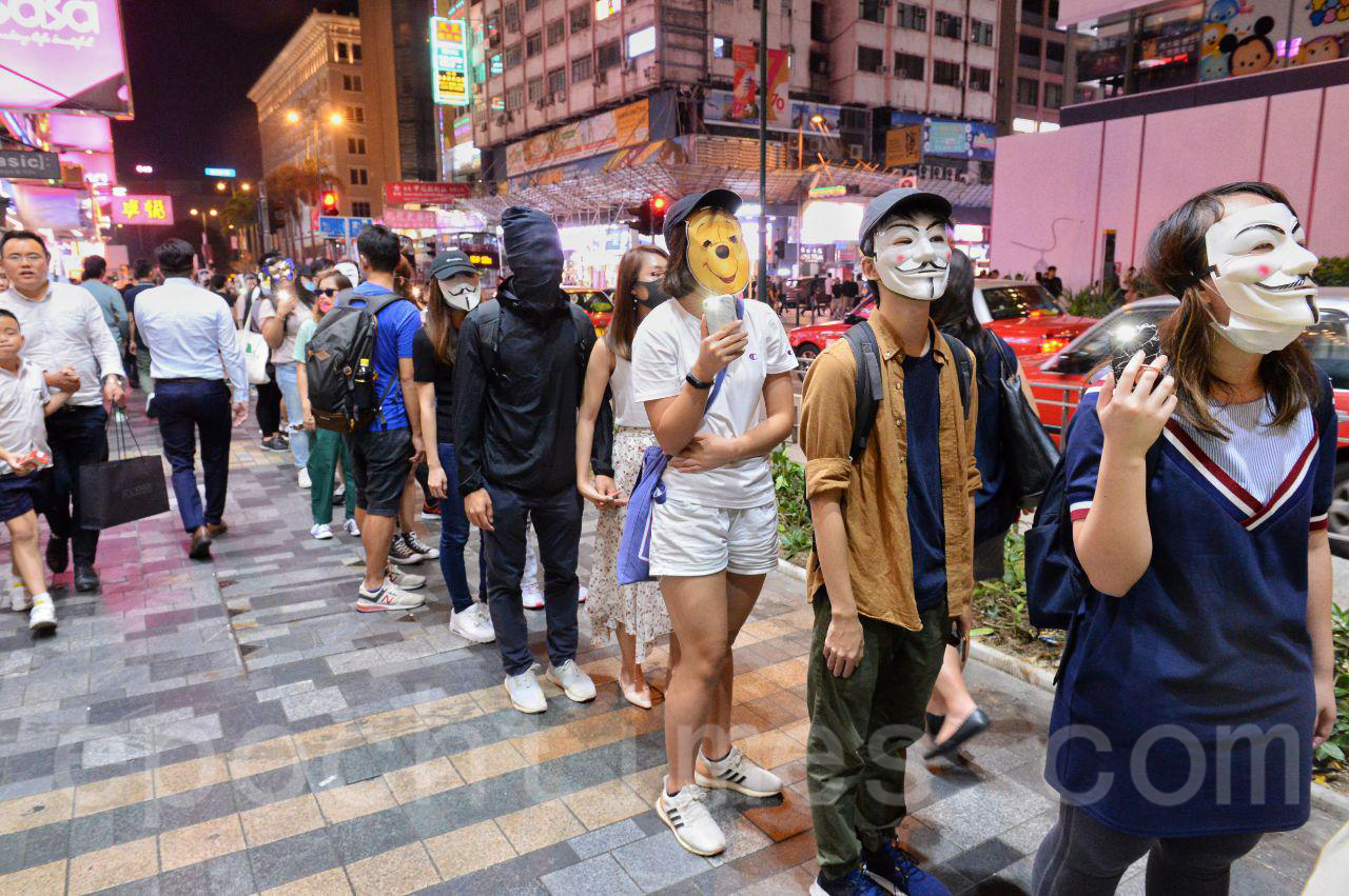 18日香港市民不為當局打壓升級，發起十八區「和你拖·面具人鏈」行動，抵制當局的《禁蒙面法》。（宋碧龍/大紀元）