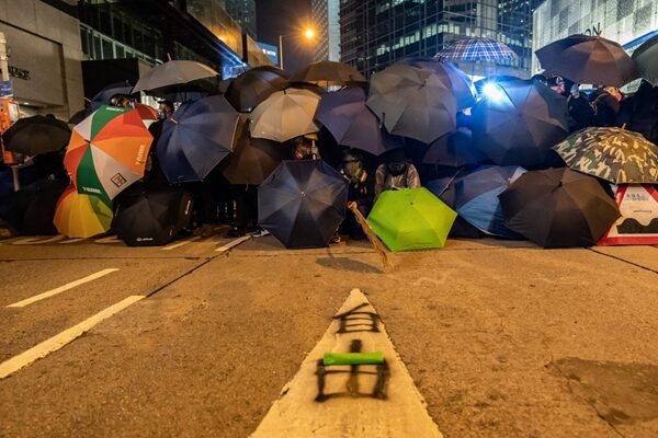 晚間，在中環德輔道，有抗爭者用雨傘設置防線與警方對峙。（Anthony Kwan/Getty Images）