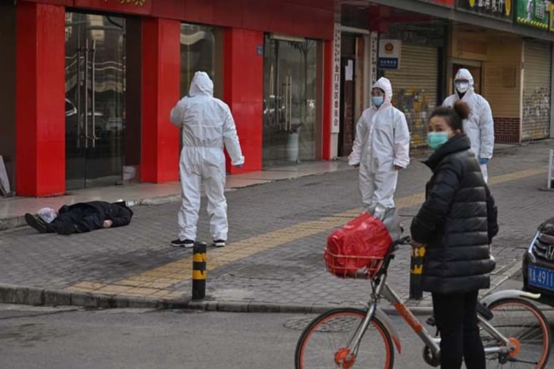 法新社刊登的照片，一名手拿購物袋的老人倒斃武漢街頭。(HECTOR RETAMAL/AFP via Getty Images)