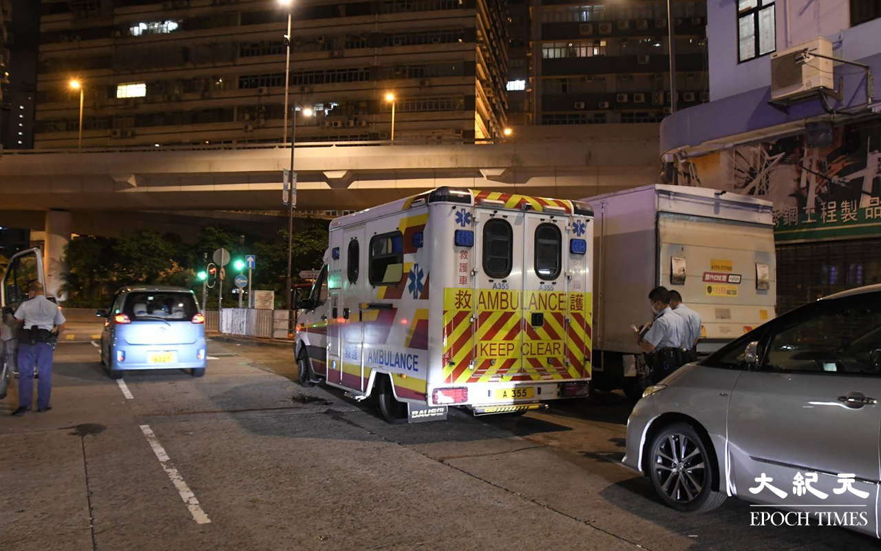 登發樓天台危坐男子被救護車送往廣華醫院治理。（麥碧 / 大紀元）