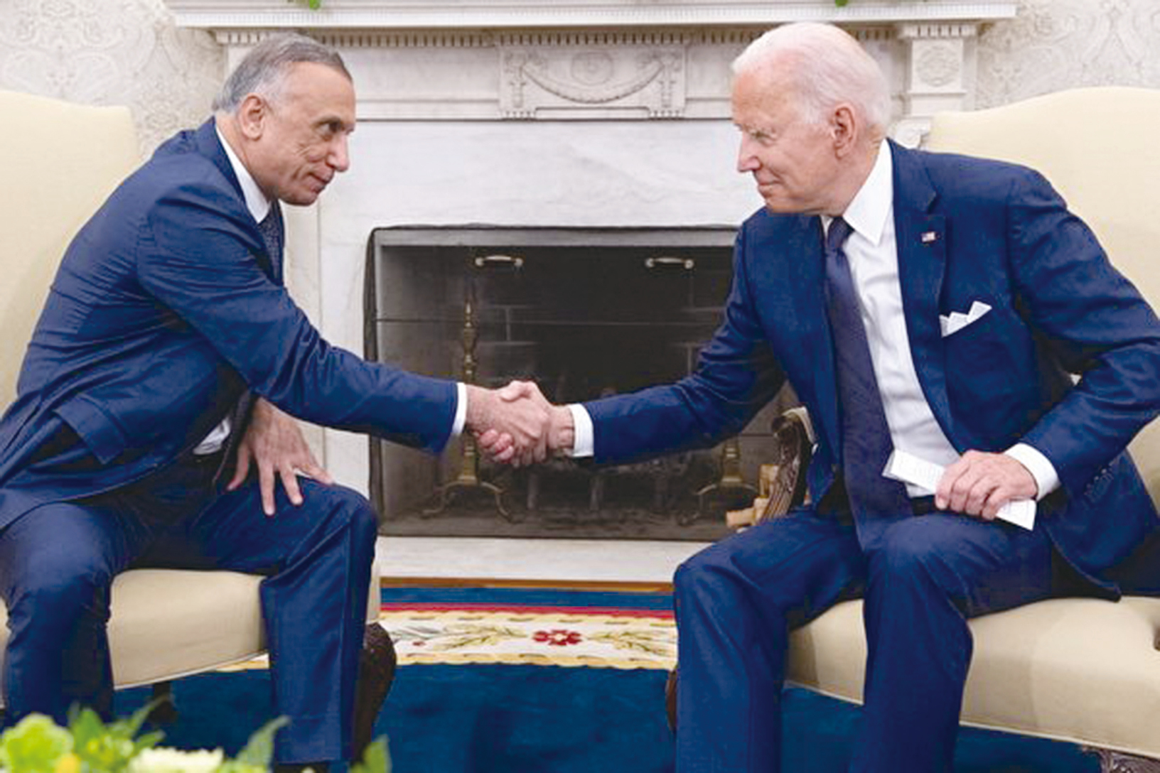 2021年7月26日，美國總統拜登（右）在白宮橢圓形辦公室與伊拉克總理卡迪米（左）會晤時握手。（SAUL LOEB/AFP）