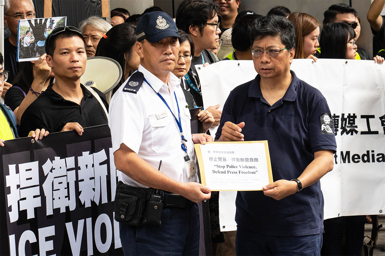 圖為2019年7月時任記協主席楊健興向警方遞送請願信，要求警方尊重新聞自由。（大紀元資料圖片）