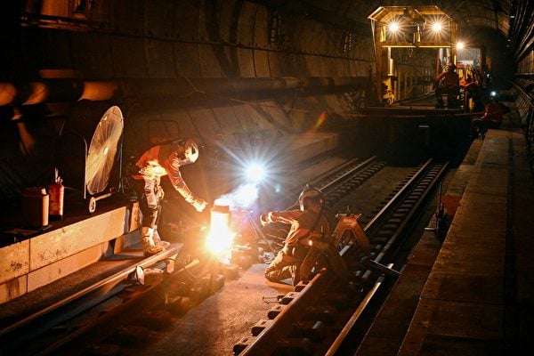 2023年2月12日，在英法海底隧道（Channel Tunnel）維修期間，工人們正在焊接鐵軌。（Francois Lo Presti/AFP）