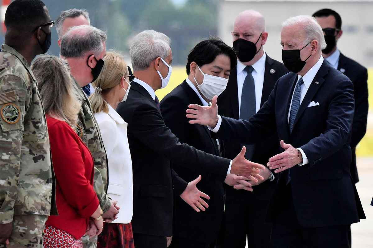 美國總統拜登於周日（5月22日）下午抵達日本，日本外相林義政（Yoshimasa Hayashi，中）和美國駐日本大使Rahm Emanuel（左）迎接。（Kazuhiro NOGI / AFP）