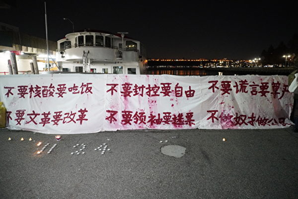 2022年11月29日，紐約中國留學生於中領館對街舉辦的集會中，重現「孤勇者」彭載舟在北京四通橋上掛著的布條與標語。（林宜君／大紀元）