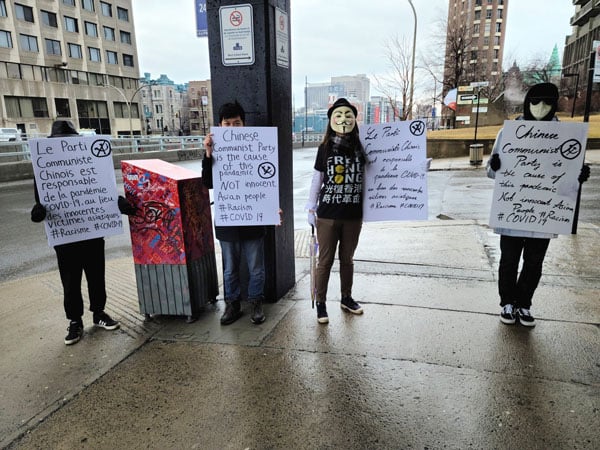 2020年3月20日，加拿大滿地可一些華人學生走上街頭，用展板向民眾呼籲，目前蔓延全世界的疫情禍因是中共，應將中共與華人區分開來。（滿地可公民會提供）