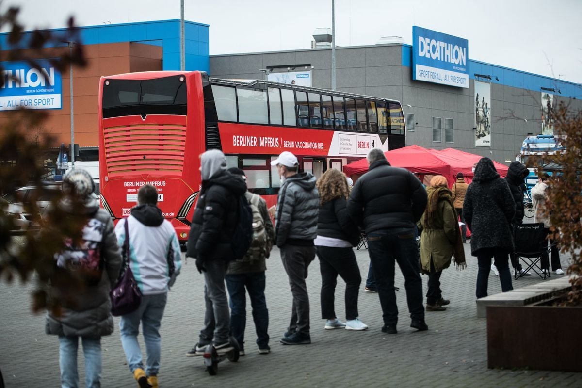 2021年11月17日，德國柏林，民眾在一輛巴士前排隊等候接種COVID-19（新冠病毒）疫苗。（Stefanie Loos/AFP via Getty Images）