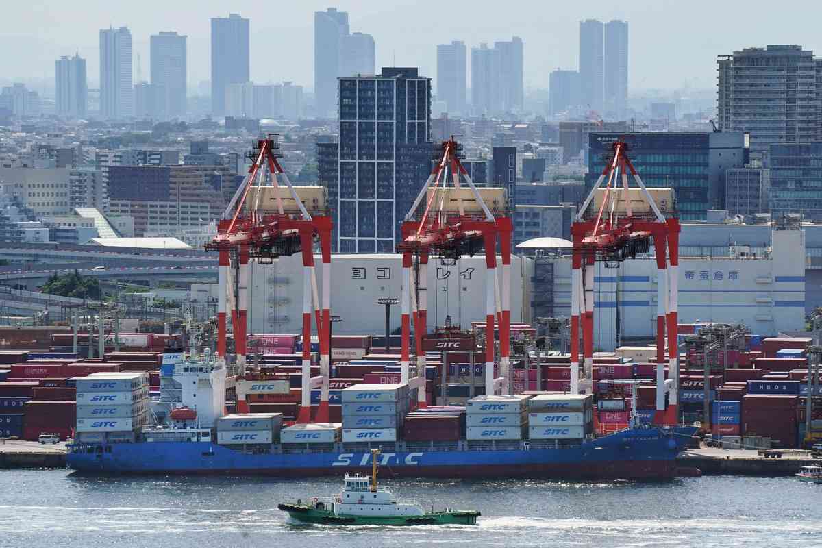 2025年8月14日,東京國際貨運碼頭,貨櫃與一艘貨櫃船正在進行裝卸作業。(Kazuhiro NOGI/AFP)