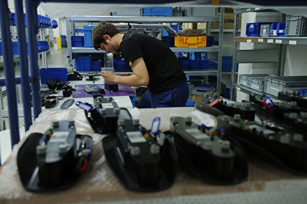 2022年9月29日，德國柏林，Onomotion工廠正式開業當天，一名工人正在裝配廠組裝電動貨運單車的儀表板顯示器。（Sean Gallup/Getty Images）
