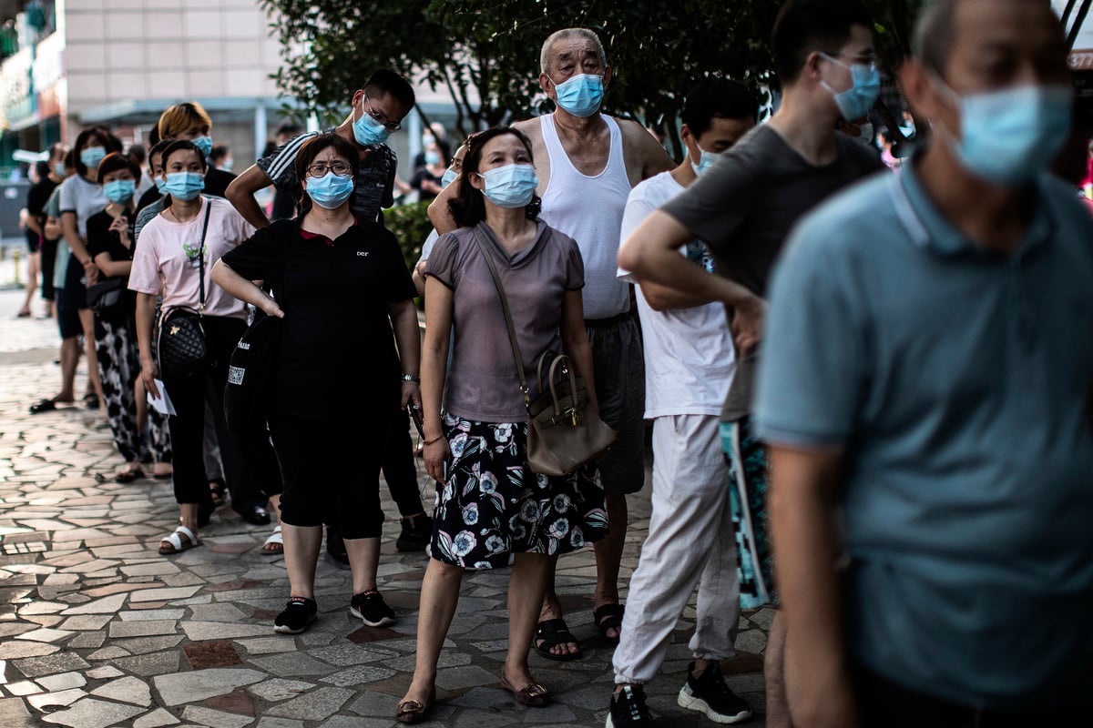 湖北武漢再次爆發疫情，在全市範圍內啟動核酸檢測。圖為2021年8月3日，武漢居民們排隊接受COVID-19的核酸檢測。(Getty Images)