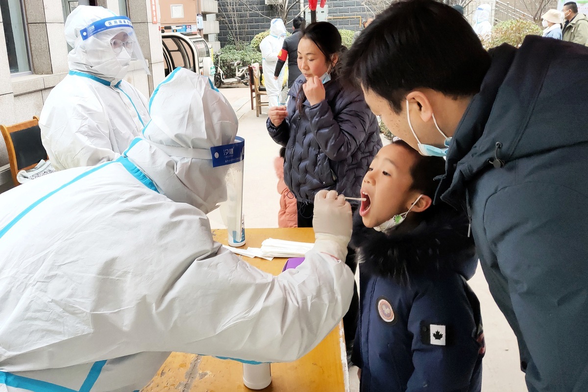 2022年1月12日，一名兒童在位於華中的河南省安陽市接受COVID-19冠狀病毒核酸檢測。（STR/AFP via Getty Images）