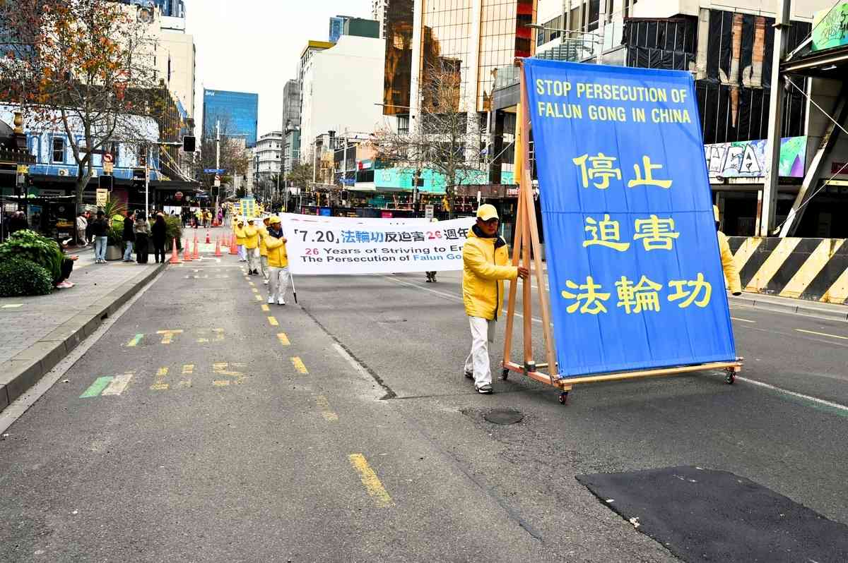 2025年7月19日,紐西蘭部份法輪功學員齊聚奧克蘭市中心伊利沙伯廣場,舉行反迫害26周年集會,並在皇后街進行了聲勢浩大的「解體中共、結束迫害」的遊行活動。圖為遊行隊伍中醒目的真相推車。(趙凱/大紀元)