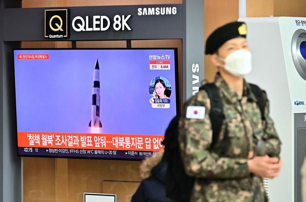 2022年1月5日，北韓疑似發射了一枚彈道導彈。圖為南韓首爾的火車站裏，一名南韓士兵走過電視新聞屏幕，屏幕上顯示著北韓導彈試驗的資料畫面。（JUNG YEON-JE/AFP via Getty Images）