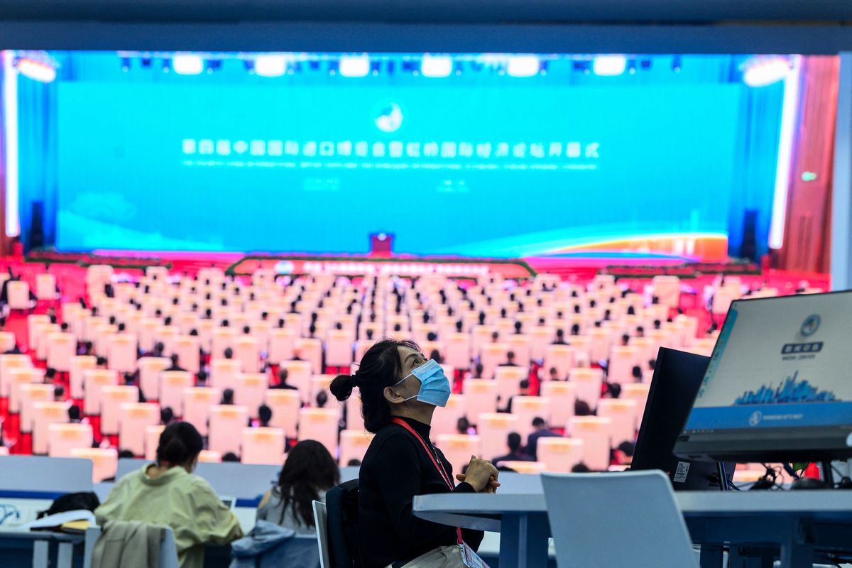 2021年11月4日，在上海的中國國際進口博覽會媒體中心，一名女士正在觀看屏幕上顯示的中國國家主席習近平在中國國際進口博覽會開幕式上講話的實時圖像。（STR/AFP via Getty Images）
