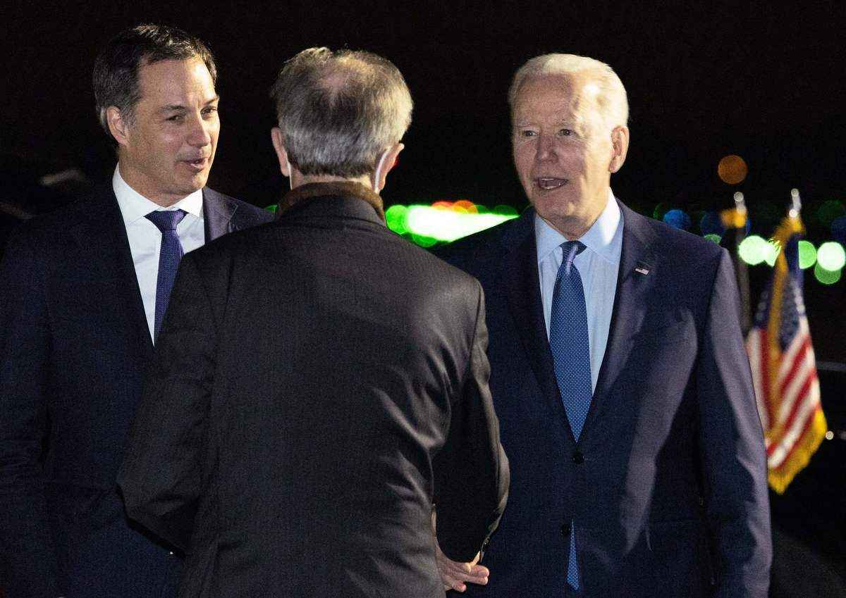 2022年3月23日，美國總統喬·拜登抵達斯廷諾克澤爾的梅爾斯布魯克（Melsbroek）軍事機場，與比利時首相亞歷山大·德克羅（Alexander De Croo）（左）等人握手。美國總統拜登將在比利時參加北約峰會，討論俄羅斯入侵烏克蘭等問題。（POOL BENOIT DOPPAGNE/BELGA MAG/AFP via Getty Images）