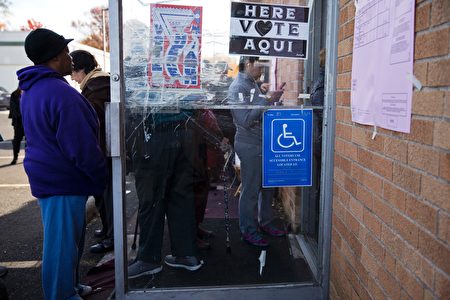 Voters wait in line at a polling station in Philadelphia, Pennsylvania, on election day November 8, 2016. America's future hung in the balance Tuesday as millions of eager voters cast ballots to elect Democrat Hillary Clinton as their first woman president, or hand power to the billionaire populist Donald Trump. As the world held its collective breath, Americans were called to make a historic choice between two radically different visions for the most powerful nation on Earth. / AFP / DOMINICK REUTER (Photo credit should read DOMINICK REUTER/AFP/Getty Images)