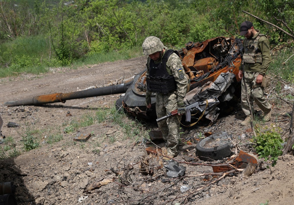 俄烏戰持續近4個月，目前仍未有結束跡象。圖為2022年6月17日，烏克蘭軍人在盧甘斯克地區Lysychansk附近一個廢棄的俄羅斯陣地檢查一輛被摧毀的俄羅斯坦克。（Anatolii STEPANOV / AFP）