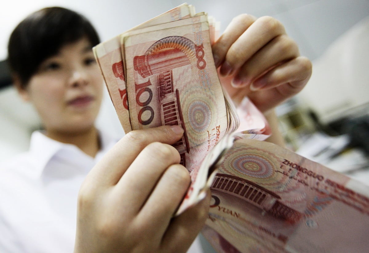 中國安徽省一家銀行的行員在清點人民幣鈔票。（STR/AFP/Getty Images）