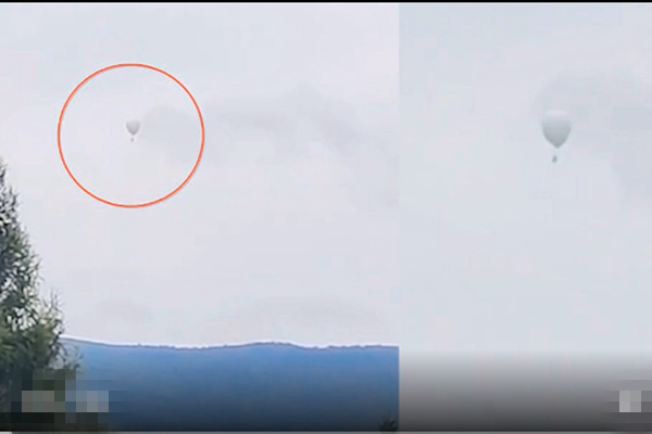 黑龍江牡丹江一名男子，坐在氫氣球上摘松塔時，氣球被風吹走。（影片截圖）