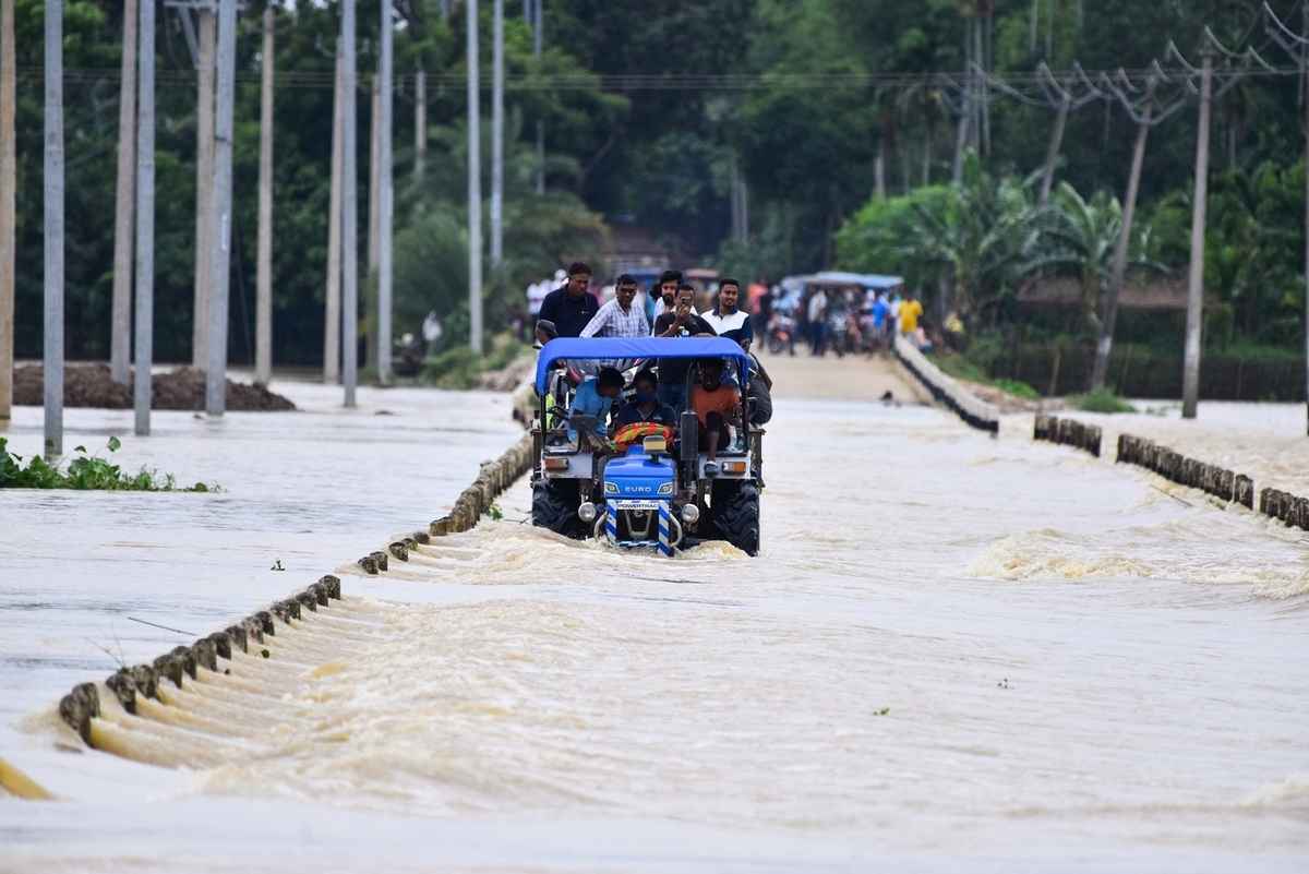 2025年6月3日,印度阿薩姆邦霍賈伊區(Hojai district)發生嚴重洪澇,人們帶著物品,乘坐拖拉機轉移至安全地帶。(Anuwar Hazarika/Middle East Images/AFP via Getty Images)