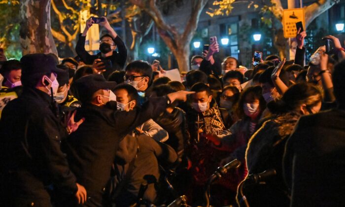 2022年11月27日，在上海，抗議政府「新冠清零」政策的示威活動中，警察和民眾發生衝突。（Hector Retamal/AFP via Getty Images）