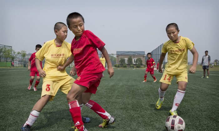 中國廣東省恆大國際足球學校的一個練習場上，一群孩子們在踢足球。（Kevin Frayer/Getty Images）