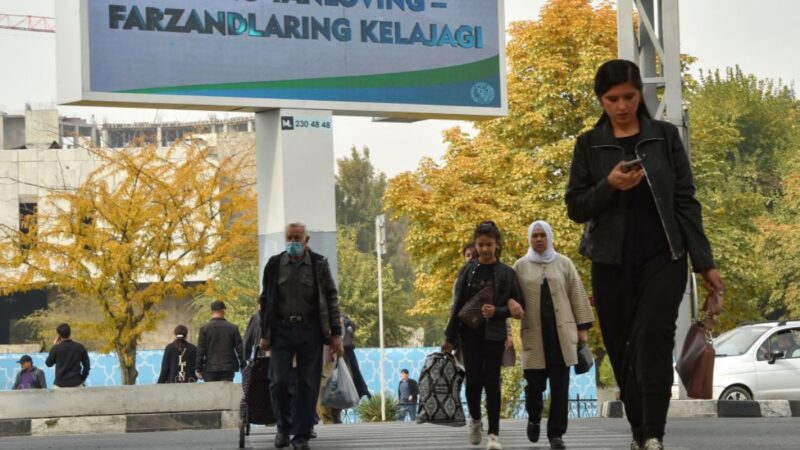 2021年10月20日，一些行人從宣傳烏茲別克總統選舉的電子廣告牌前走過。（VYACHESLAV OSELEDKO/AFP via Getty Images）